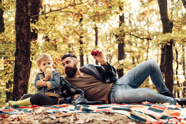 Father and son camping. Man with beard, dad with young son in autumn park. Happy joyful father with a cute son vacation. Fathers day - concept. - Photo, Image