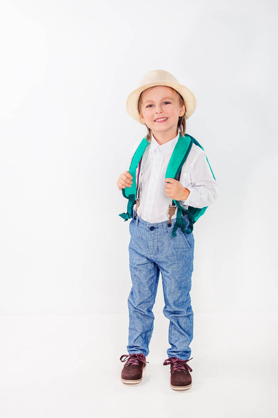 Little boy with a backpack on a white background. Stationery for school. - Foto, immagini