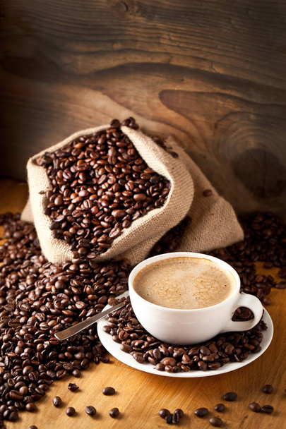 cup of coffee and  cake on coffee beans. - Foto, Imagem
