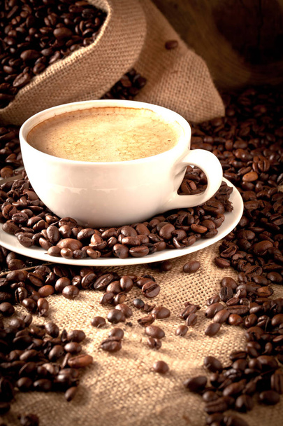 cup of coffee and  cake on coffee beans. - Zdjęcie, obraz