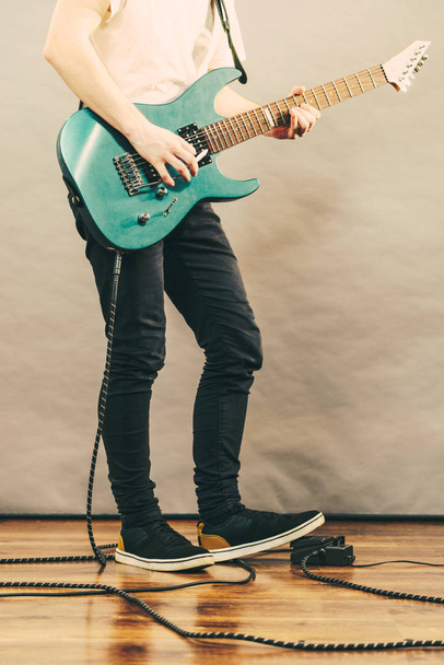 Unrecognizable teenage man playing on electric guitar indie rock. Musical instruments concept. - Fotó, kép