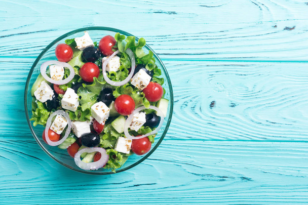 Fresh vegetables greek salad . Healthy food on wooden background - Фото, изображение