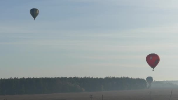 Balloon flying in the sky. Colorful hot air balloon flying over rock landscape in blue sky. Morning balloon flight over the fields and forests. - Footage, Video