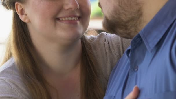 Beautiful plus size woman hugging her boyfriend, enjoying romantic outdoor date - Felvétel, videó