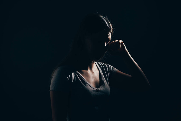 Sad woman in dark room. Depression and anxiety disorder concept - Foto, Imagen