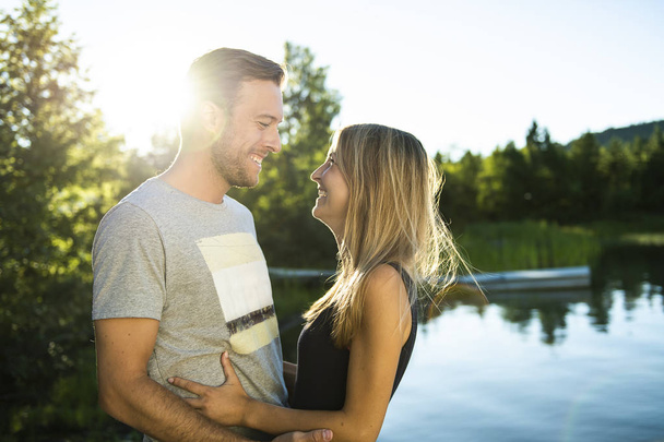 Couple outdoors by lake having good time - Photo, Image