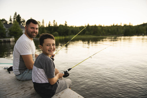 Cool Dad and son fishing on lake - Foto, Bild
