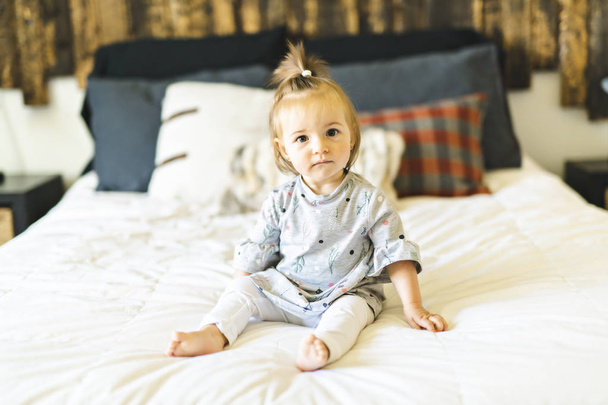 Cute little baby girl on bed at home - Φωτογραφία, εικόνα