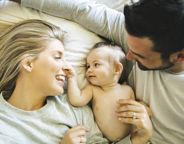 Family on bed with his baby on the morning - Photo, Image
