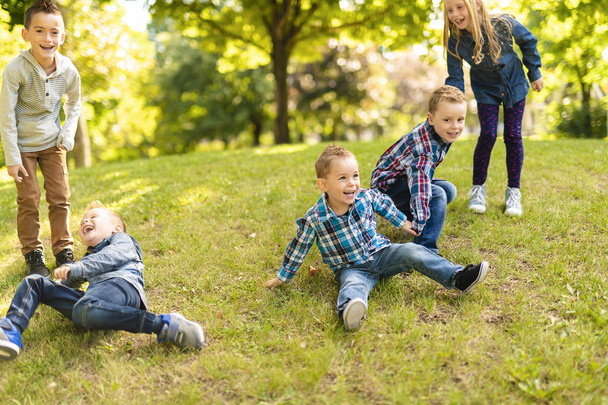 A group of children in spring field having fun - Photo, Image