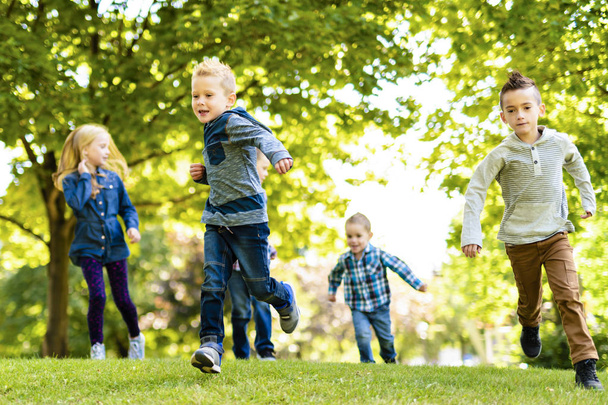 A group of children in spring field having fun - Photo, Image