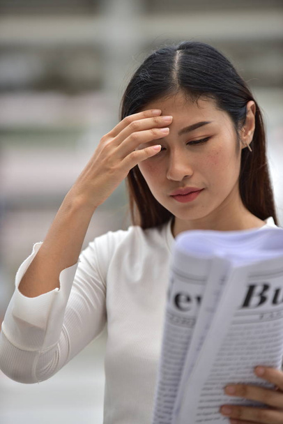 Asian woman reading newspaper - Photo, Image