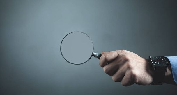 Hand showing magnifier. Business concept - Photo, Image
