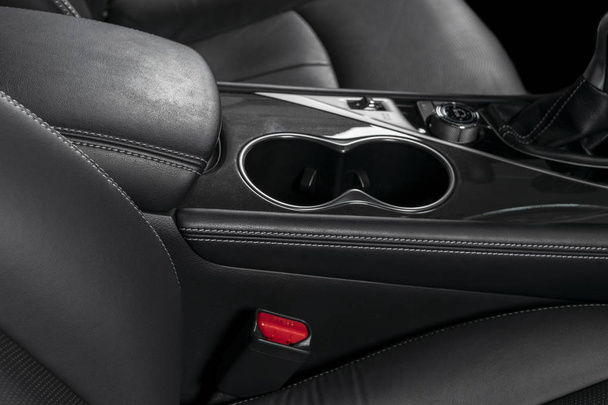 Modern luxury car black leather interior. Part of leather car seat details with stitching. Interior of prestige modern car. Comfortable perforated leather seats. Black perforated leather. Car detailing - Φωτογραφία, εικόνα