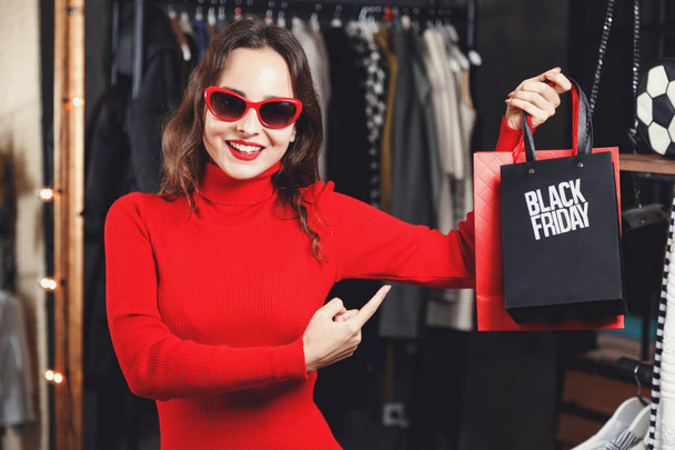Successful Girl Showing Black Friday Bag - Photo, image
