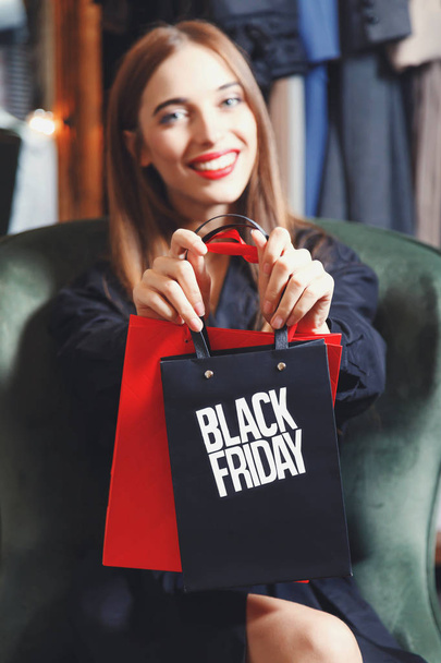Elegant Woman Showing Black Friday Bag - Valokuva, kuva