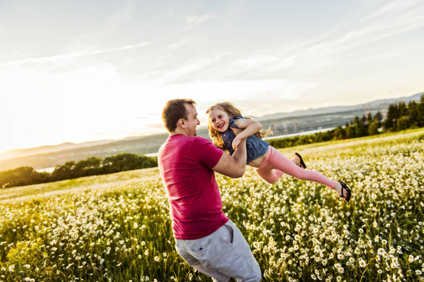 Father spending time with daughter during the sunset. - 写真・画像