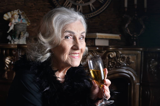 Portrait of senior smiling woman with champagne  - Foto, afbeelding
