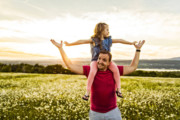 Father spending time with daughter during the sunset. - Photo, image