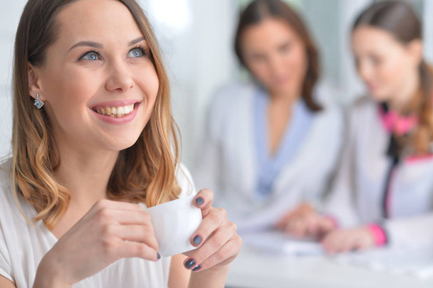 young woman during coffee break in modern office - Photo, Image