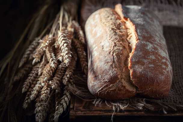 Homemade loaf of bread in rustic kitchen - Zdjęcie, obraz