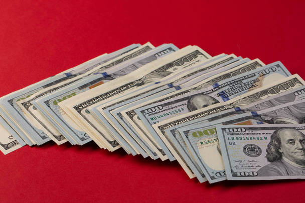 Stack of one hundred dollar bills new and old design on red background. casino bet - Photo, Image