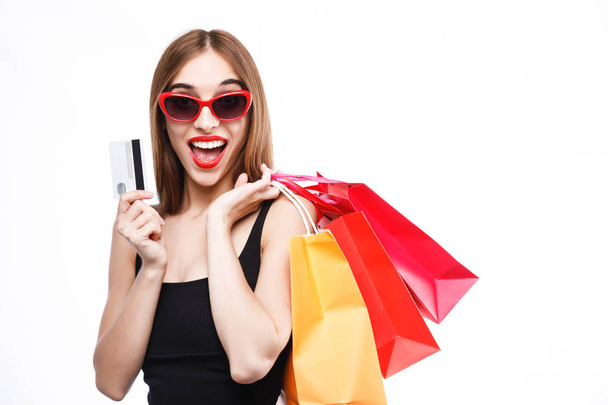 Gorgeous Woman Holding Card And Shopping Bags - Фото, изображение