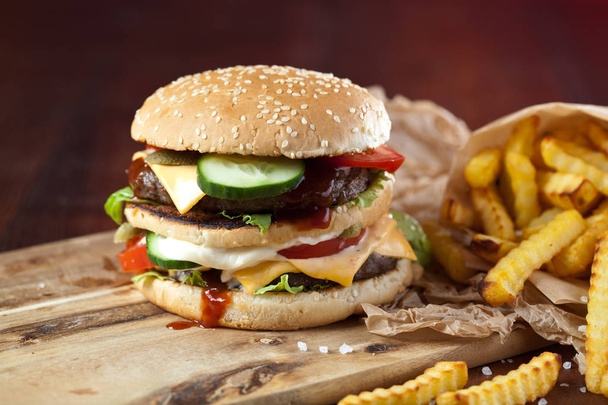 Fast food hamburger and french fries on a wooden Background - Φωτογραφία, εικόνα