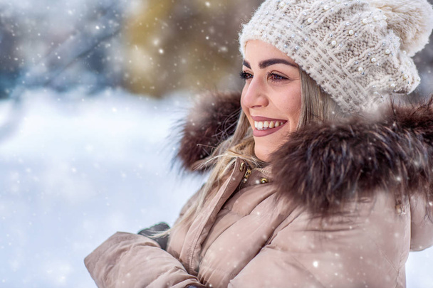 wintertime- Winter portrait of young smiling woman close-up - Photo, Image