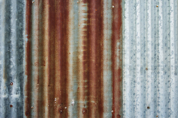 background of peeling paint and rusty old metal. zinc wall texture pattern background rusty corrugated metal old decay. photo - Zdjęcie, obraz