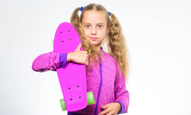 Plastic skateboards for everyday skater. Child hold penny board. Penny board of her dream. Choose skateboard that looks great and also rides great. Best gift for kid. Kid long hair carry penny board - 写真・画像