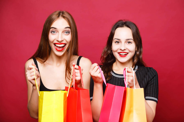 Two Cute Girlfriends Holding Many Shopping Bags - Фото, зображення