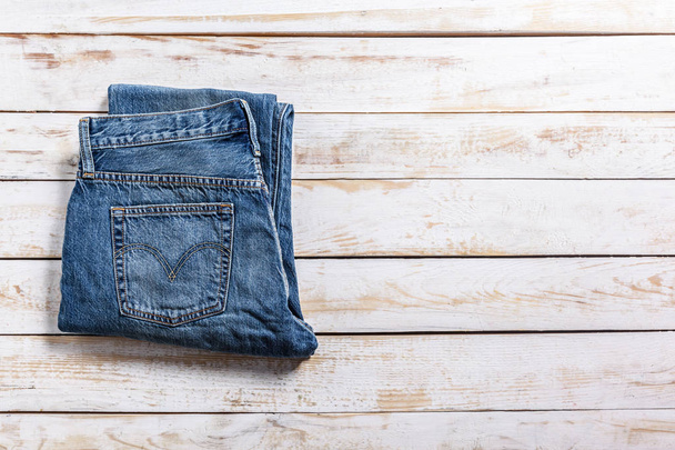 close up of Jeans on wooden background - Zdjęcie, obraz