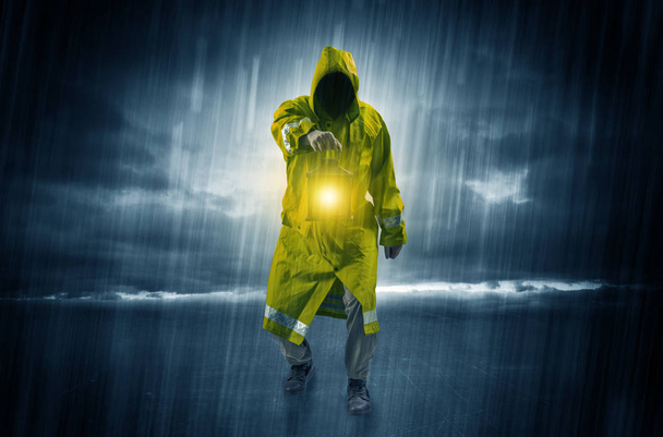 Man walking in storm with lantern - Φωτογραφία, εικόνα