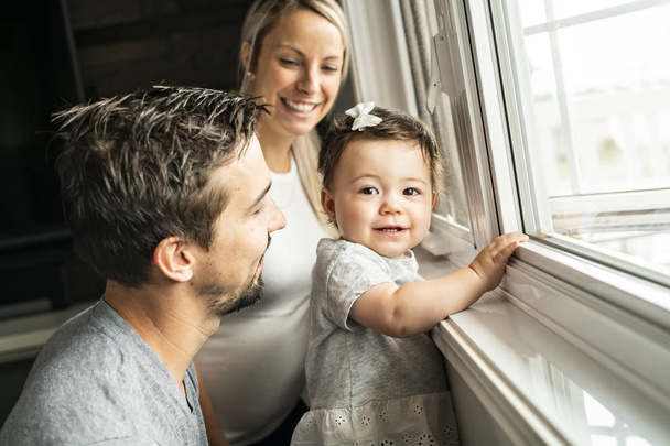 Family sit near window on the livingroom - Foto, Imagem