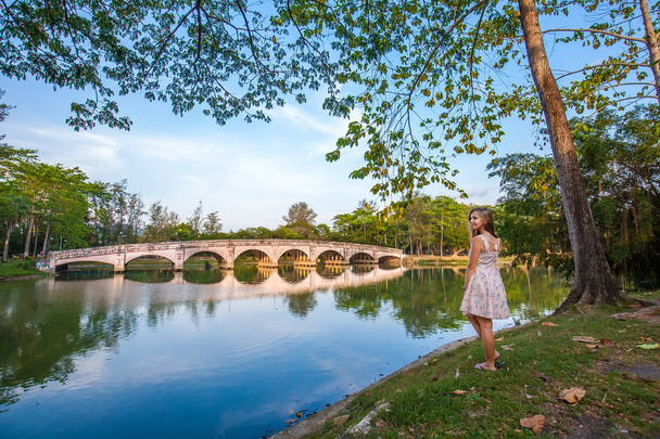 Girl near lake with bridge - Zdjęcie, obraz
