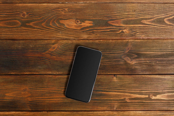 mobile phone on a wooden table - Foto, Imagem