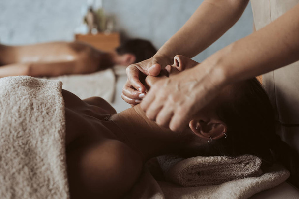 Woman having a facial massage at the spa - 写真・画像