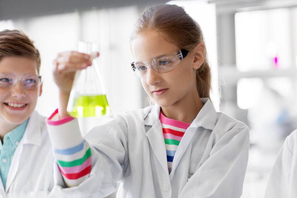 kids with test tubes studying chemistry at school - Photo, image