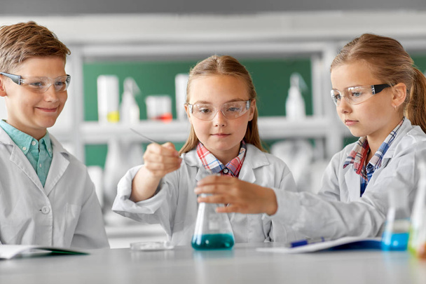 kids with test tube studying chemistry at school - Photo, Image