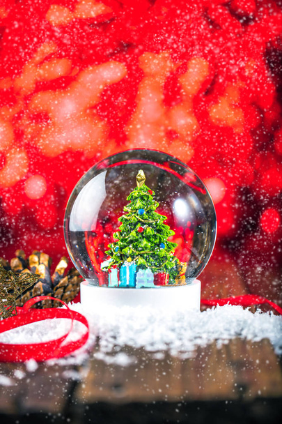 Christmas snow globe on wooden background - Foto, Bild