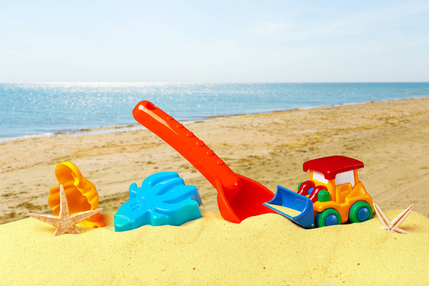 Plastic toys for beach with ocena on the background  - Fotoğraf, Görsel
