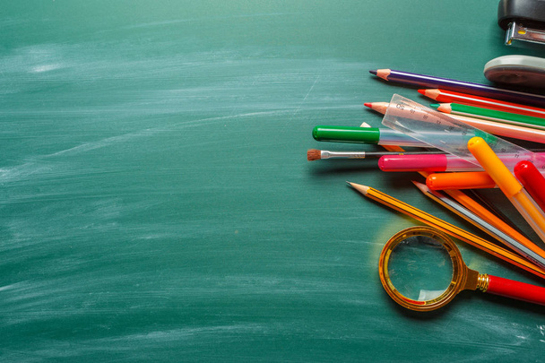 School supplies on chalkboard green background - Photo, Image