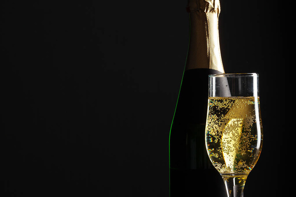 champagne wine glass and bottle on black background - Fotografie, Obrázek