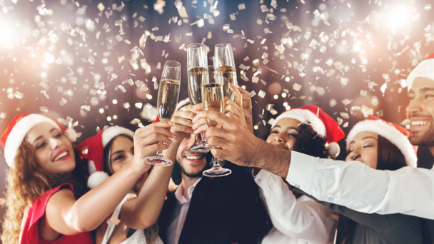 Diverse friends clinking with champagne glasses on New Years Eve - Фото, изображение