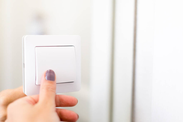 Hand turning wall light switch - Foto, immagini