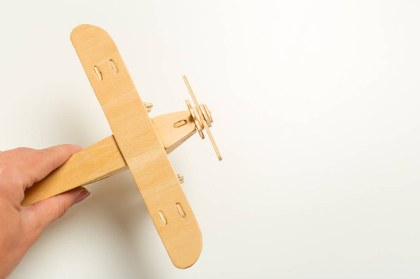 hand holding toy airplane on white background   - Foto, Bild