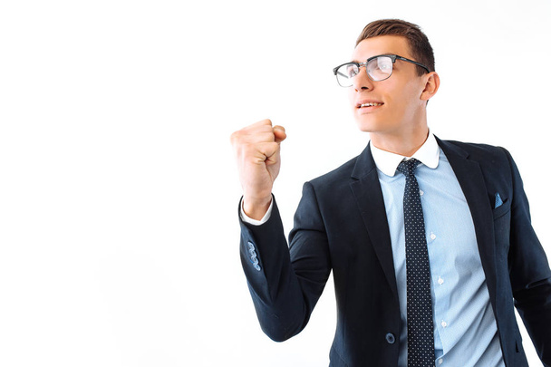 Successful businessman in glasses and suit, shows a gesture of success and victory, on a white background - Foto, Bild