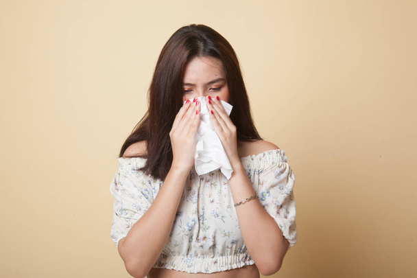 Young Asian woman got sick and flu on beige background - 写真・画像