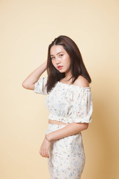 Portrait of beautiful young Asian woman on beige background - Zdjęcie, obraz